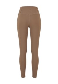 Leggings marron côtelés avec une taille haute. Texture lisse et design ajusté. Coutures renforcées le long des jambes. Pas de motifs visibles ni d'accents.