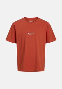 Red cotton T-shirt with a crew neck, short sleeves, and white text "Originals Studio" on the front. Smooth texture, relaxed fit.