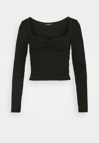 Top corto nero a maniche lunghe con dettagli arricciati sullo scollo quadrato, posato su uno sfondo bianco.