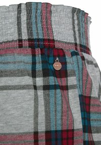 Gray fabric with a multicolored plaid pattern in teal, red, and black; features an elastic waistband and a small metal logo accent.