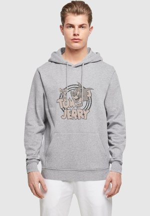 Gray hoodie with a front kangaroo pocket, featuring a Tom and Jerry graphic in black and beige shades. Drawstring hood and ribbed cuffs.