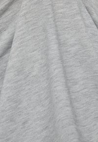 Light gray fabric with a slight sheen, featuring a textured weave with fine horizontal lines and subtle glitter accents.