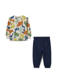 Katoenen peuteroutfit met een crèmekleurig trui met ronde hals en multikleurige dinosaurussen, en marineblauwe elastische broek met een zak.