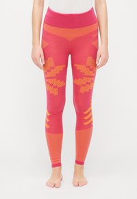 Red and orange patterned leggings with a wide pink waistband. Features geometric designs and ribbed texture along lower legs.