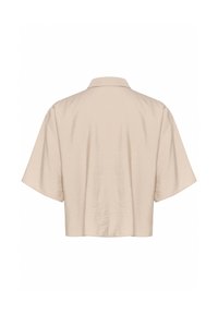 Beige short-sleeve shirt with a collar, featuring a smooth, slightly crinkled texture and a cropped hem. Clean and simple design.