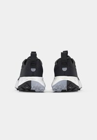 Black athletic shoes with textured mesh uppers, white midsole, and rubber outsole featuring multi-directional traction patterns.
