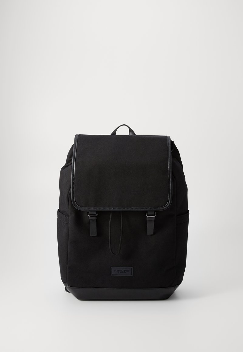 Black fabric backpack featuring a flap closure, two front straps, side pockets, and a textured finish with a leather bottom accent.
