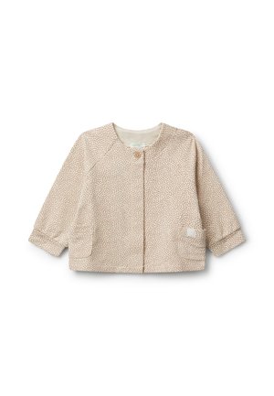 Helle beige Jacke mit kleinen braunen Flecken, mit Rundhalsausschnitt, Knopfverschluss und zwei vorderen Taschen. Weicher Stoff mit langen Ärmeln.