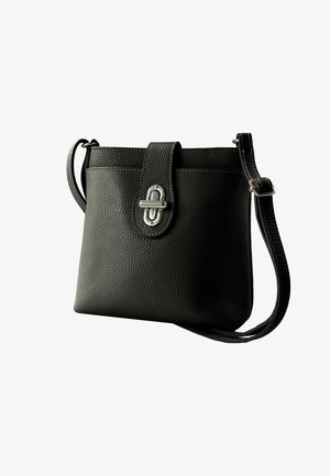 Black leather handbag with a textured finish, featuring a top flap closure and silver-tone hardware. Adjustable shoulder strap included.