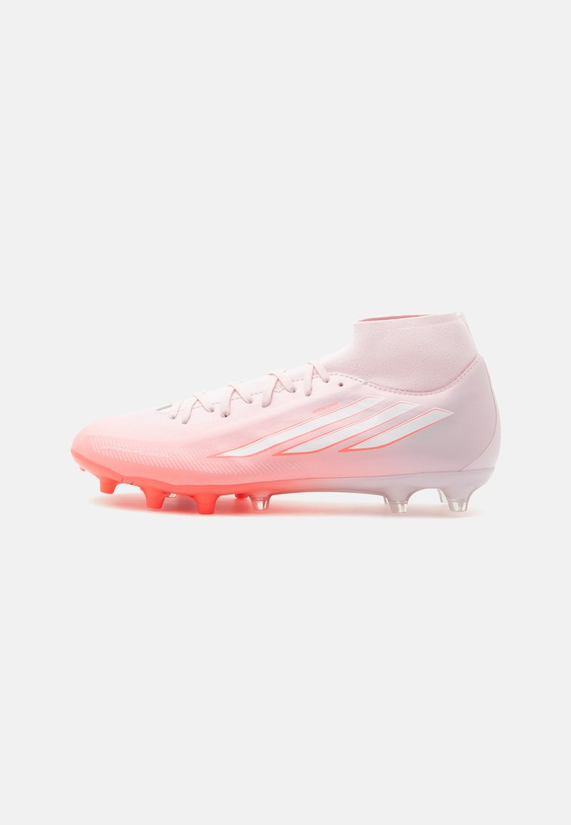 Light pink football cleat with high ankle collar, orange-tinted sole studs, and white Adidas stripes on the side.