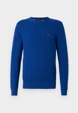 Blue knit sweater, crew neck, long sleeves, textured pattern, ribbed cuffs and hem, small logo accent on chest, made from soft fabric.