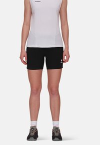 Black athletic shorts with a fitted design and logo near the hem; paired with a white sleeveless top, showcasing a simple, clean look.