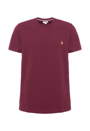 T-shirt in cotone bordeaux con maniche corte, collo rotondo, spacchetti laterali e un piccolo logo ricamato dorato sul petto.
