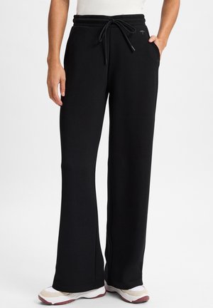 Schwarze Sweatpants mit weiter Beinweite, weichem Material, elastischem Bund, Kordelzugverschluss und seitlichen Taschen.