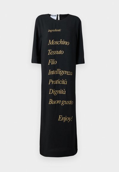 Black dress with a loose fit, featuring gold text listing ingredients. Round neckline and three-quarter sleeves. Simple, minimalist design.