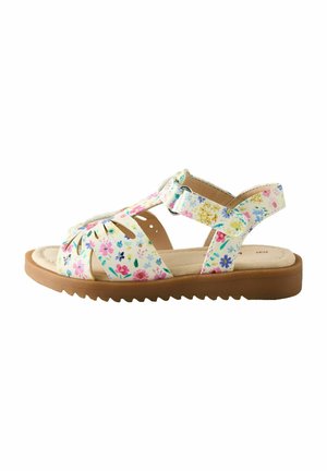Children’s open-toe sandal with brown sole and white straps featuring multicolored small floral patterns and adjustable ankle strap.