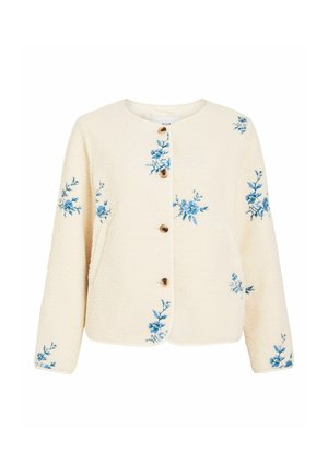 Veste boutonnée de couleur crème avec une texture, ornée de broderies florales bleues éparpillées sur les manches et le devant, dotée d'un col rond et de manches longues.