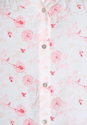 Weiße Bluse mit pinkem Blumenmuster und filigranen Blättern. Sie hat eine Knopfleiste mit runden, schimmernden Knöpfen. Glatte Textur.