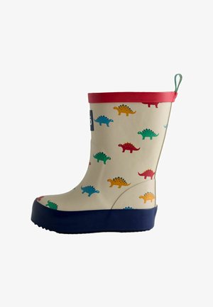 Botte de pluie enfant avec base crème, motifs colorés de dinosaures, bordure rouge en haut, semelle bleu marine et languette verte au talon.