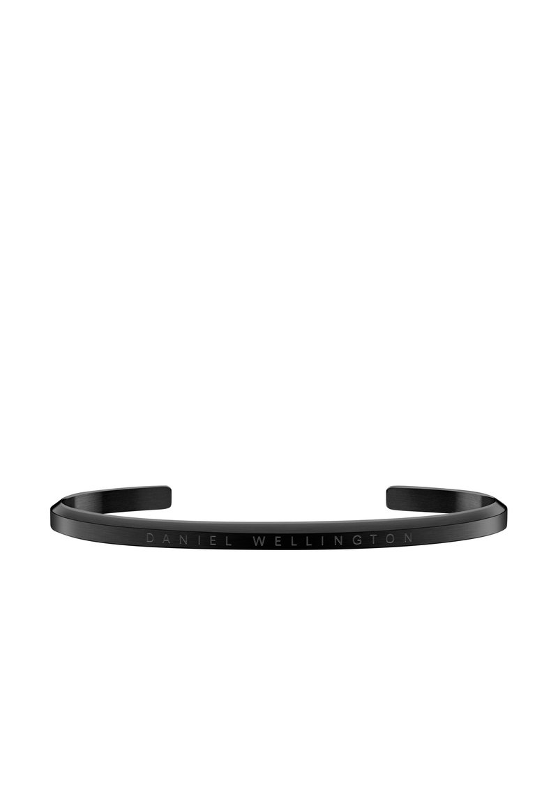 Fekete fém karszalag letisztult, minimalista dizájnnal. Az külső felületén gravírozott "DANIEL WELLINGTON" felirat található. Sima textúra, nyitott végek.