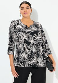 Schwarzes Oberteil mit floralen Mustern in Off-White, V-Ausschnitt und dreiviertel Ärmeln, gefertigt aus einem glatten, leichten Stoff.