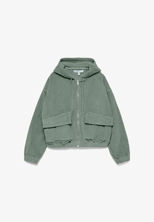 Veste en velours côtelé verte avec capuche, fermeture éclair et deux poches avant. Présente un design court et un ourlet élastique pour un look ajusté.