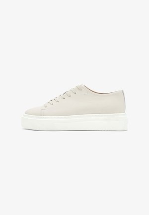 Cream-colored leather low-top sneaker with textured side, lace-up front, and thick white platform sole, shown from the outer side.