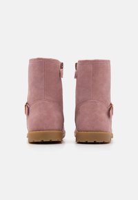 Pink faux leather ankle boots with a smooth texture, featuring a side zipper and a brown rubber sole. Back view highlights simple design.
