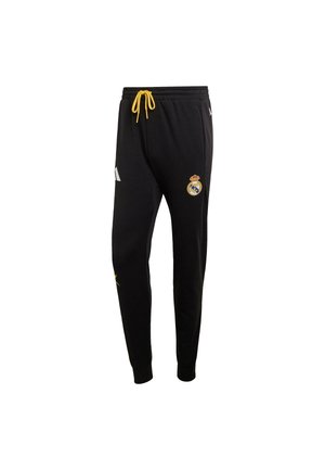 Pantalones deportivos negros con cordón, con un detalle amarillo, franjas laterales blancas y un logo del Real Madrid. Tejido suave y diseño ajustado.