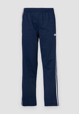 Calças desportivas azul-marinho com cintura elástica, riscas laterais brancas e logótipo bordado na coxa esquerda. Textura do tecido lisa.