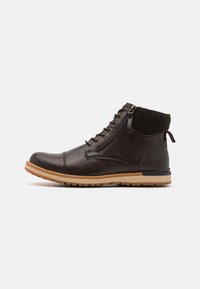 Brown leather ankle boot with a textured collar, round toe, lace-up front, and rubber sole featuring a contrasting light brown strip and zipper.