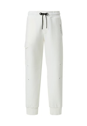 Pantaloni della tuta bianchi in un fit rilassato, con vita regolabile, tasche laterali e sottili dettagli neri. Tessuto morbido, polsini a costine.