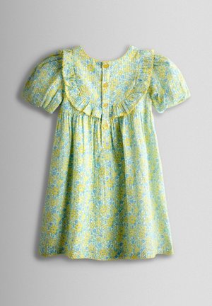 Virágos ruha rövid, buggyos ujjakkal, világoskék háttérrel, sárga díszítésekkel, fodros gallérral és három gombbal a hátoldalán. Puha anyag.