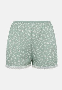 Lichtgroene katoenen korte broek met een klein wit bloemenpatroon en een kanten afwerking aan de zoom, voorzien van een elastische tailleband.