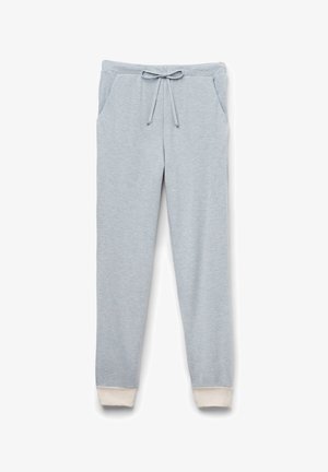 Hellgraue Jogginghose aus weichem Material, mit einer Kordelzugbund, Seitentaschen und weißen gerippten Bündchen an den Knöcheln.