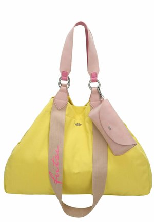 Yellow canvas bag with pink leather straps, silver hardware, and a matching pink wallet. Features a logo and logo detail in pink on the side.
