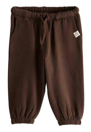 Brune elastiske joggingbukser med talje- og ankelbind, snøre og sidelommer, med et lille stofmærke med regnbue-design.