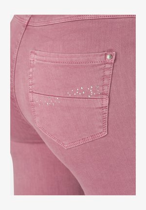 Rosa Jeans aus Denim verfügen über eine Gesäßtasche mit einem dezenten Strassdesign darüber. Der Stoff sieht glatt und elastisch aus.