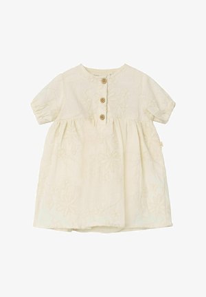 Abito in cotone color crema con motivo floreale ricamato, maniche a sbuffo corte, scollatura rotonda e tre bottoni in legno sul davanti.
