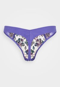String violet avec une taille élastique lisse et une broderie florale ornée dans des nuances de violet et de bleu-vert sur un fond crème.