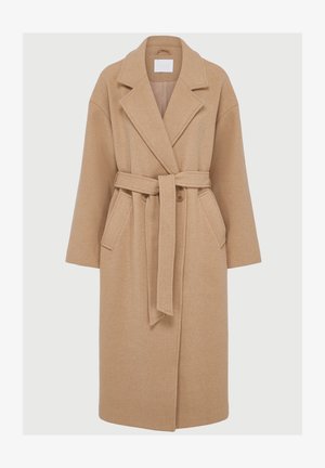 Bež nadaljni plašč iz volne z ovratnikom, dolgimi rokavi, pasom na vezanje ter dvema sprednjima žepoma. Ima sproščen kroj in mehak, teksturiran material.