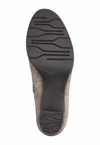 Shoe sole made of black rubber with textured grip pattern; gray suede upper shown at the edges; flat design for stability.