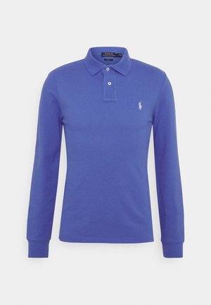 Long-sleeve polo shirt in solid blue cotton with a two-button placket and a white embroidered logo on the left chest. Ribbed cuffs.