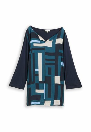 Blue and navy top with a geometric pattern featuring varying shades of blue and cream. V-neckline and three-quarter sleeves. Smooth fabric.