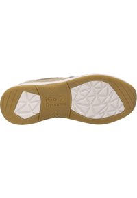 Podeszwa buta z beżowej gumy, z teksturowaną białą wkładką i heksagonalnymi wzorami. Zawiera markę "iGo Dynamic".