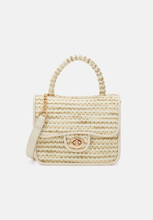 Small beige woven handbag with top handle, gold-tone turn-lock clasp, and detachable shoulder strap with chain detail.