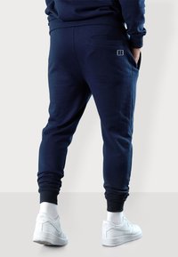 Dunkelblaue Jogginghosen aus weicher Baumwolle, mit slim fit, elastischen Bündchen und einer Gesäßtasche mit minimalistischem Logo-Detail.