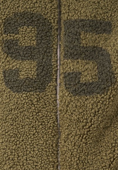Zipper closure on olive green, textured fleece fabric with large dark gray numbers "95" printed at the top.