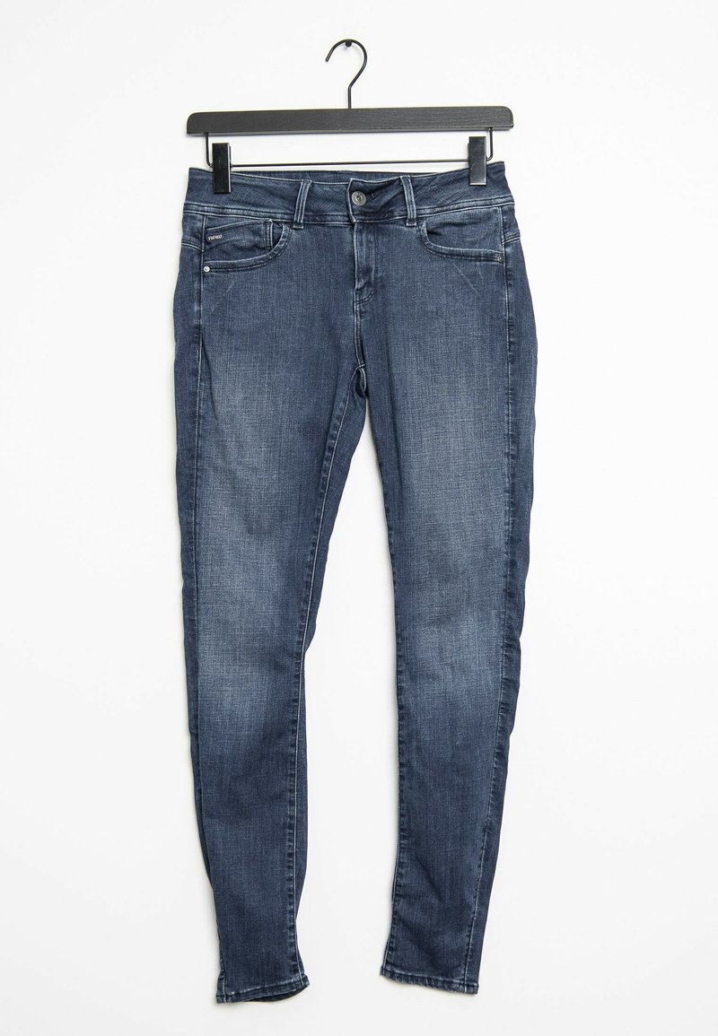 Jeans skinny en denim bleu foncé avec taille mi-haute, cinq poches et une texture lisse, fermés par un bouton et une fermeture éclair.