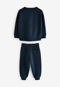 Dunkelblaues Sweatshirt und Jogginghosen-Set aus weichem Stoff. Mit einem Rundhalsausschnitt, gerippten Bündchen und einer Gesäßtasche an den Hosen.